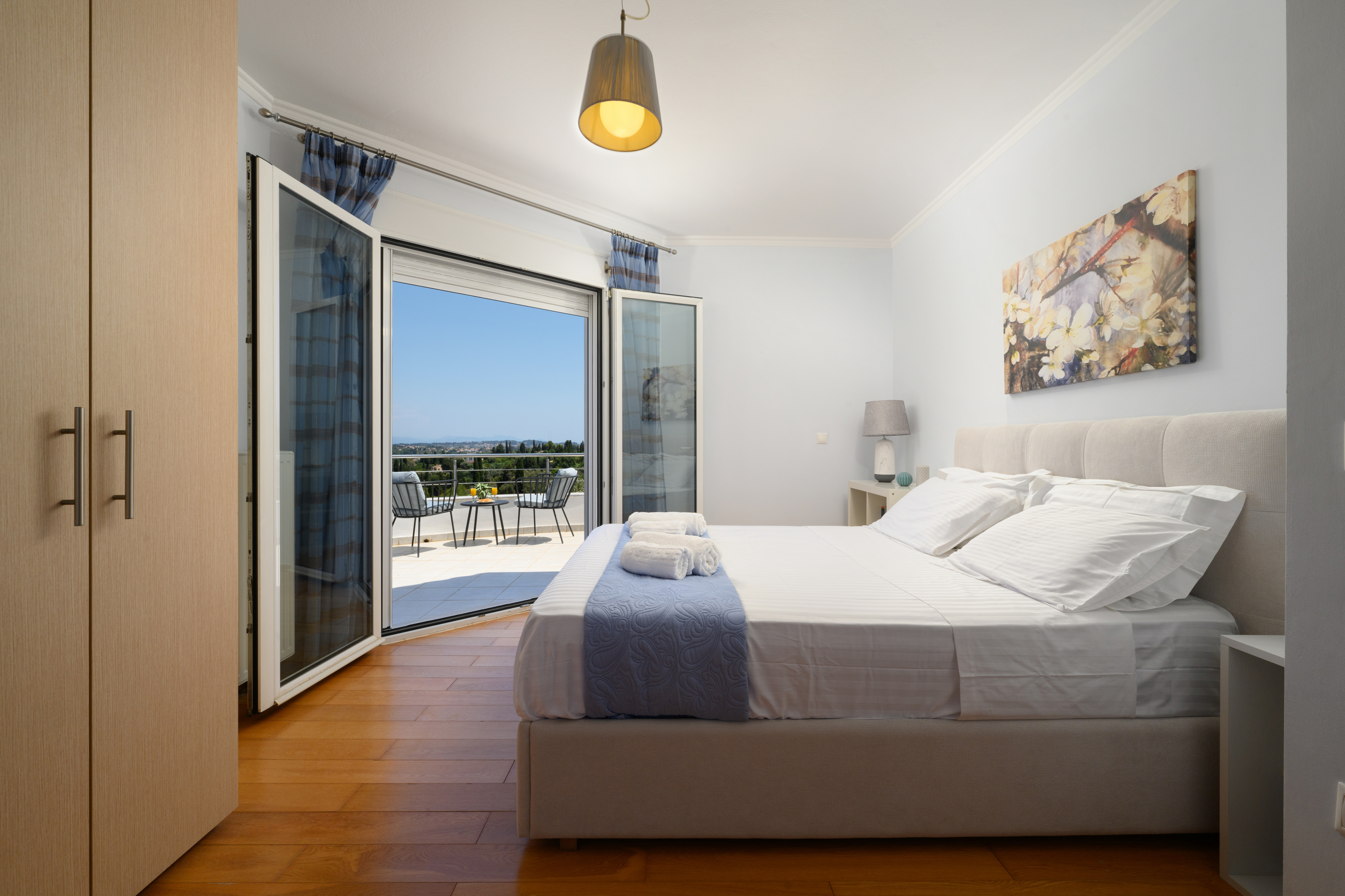 Bright bedroom with balcony access and natural light in the villa
