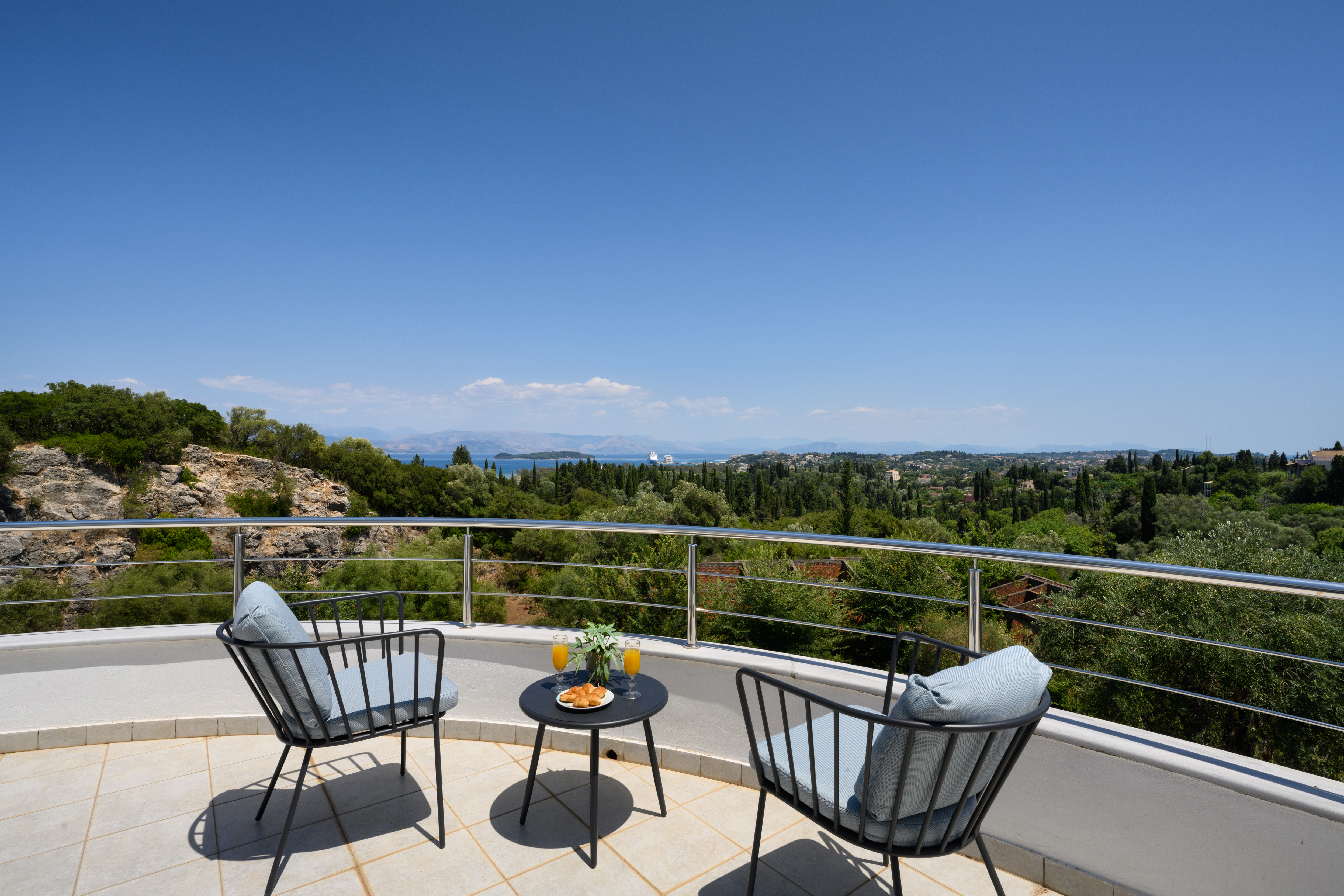 Sea view balcony with outdoor seating at Olga’s Luxury Villa in Corfu