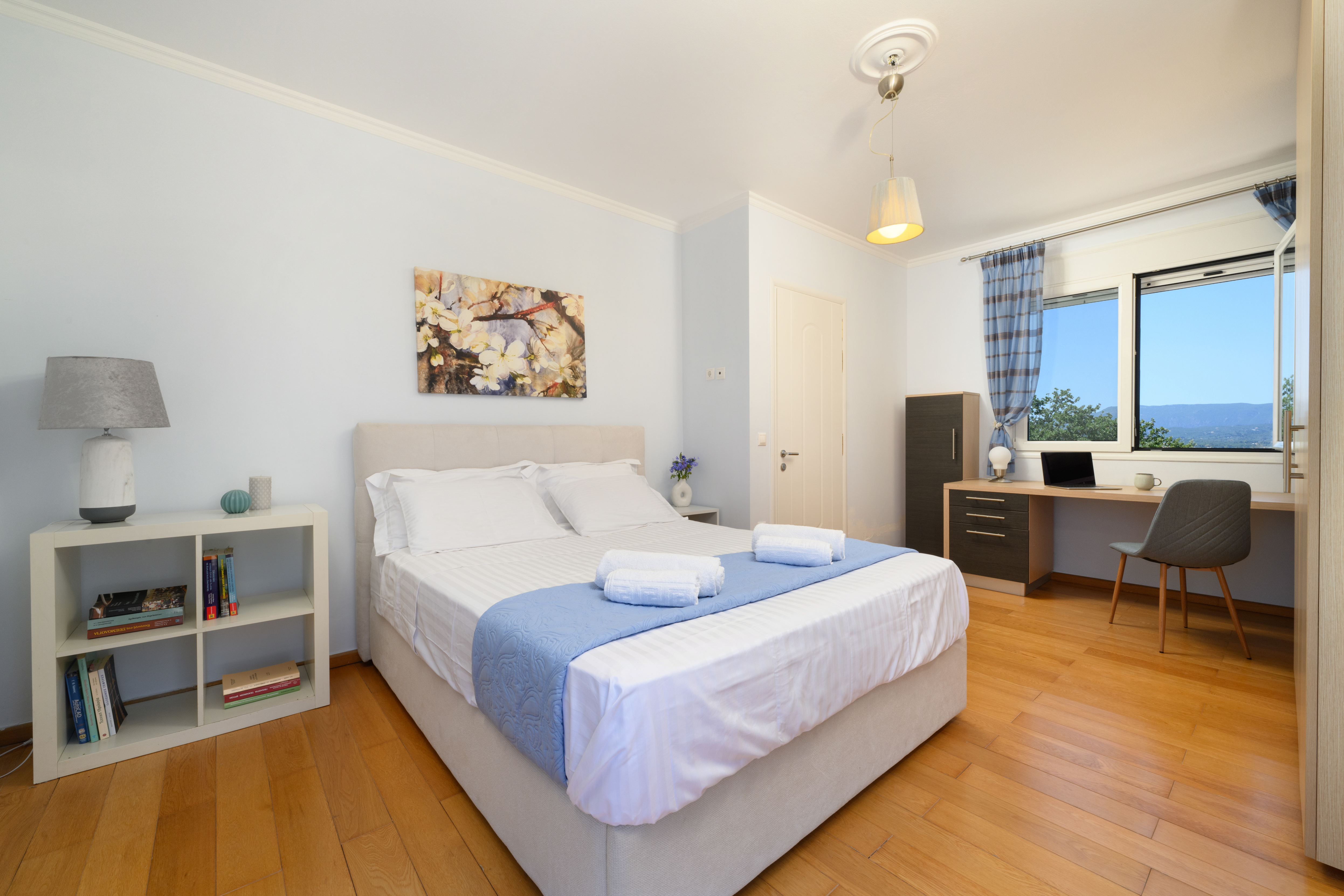 Guest bedroom with large windows at Olga’s Luxury Villa
