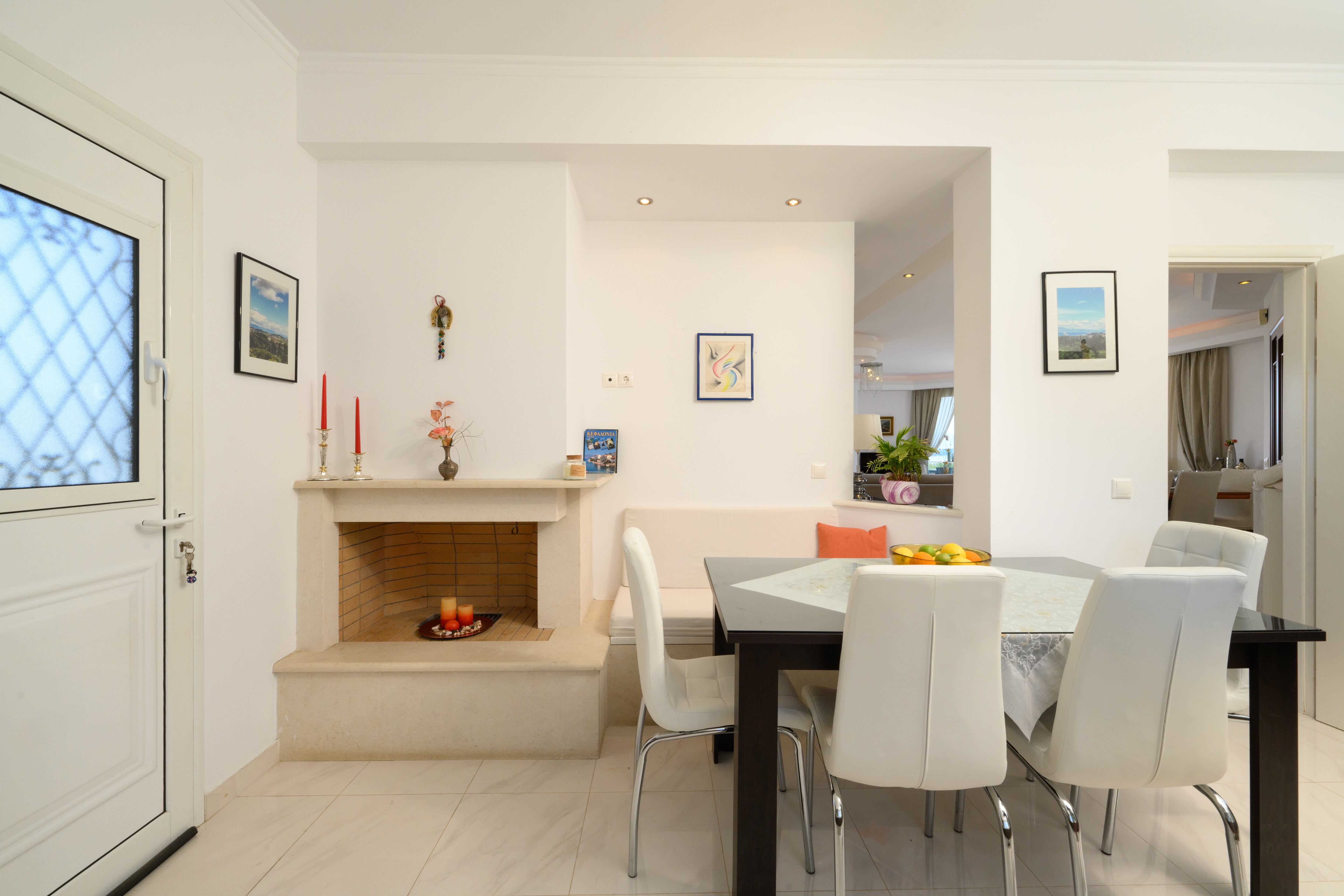 Open kitchen and dining space with fireplace inside the villa