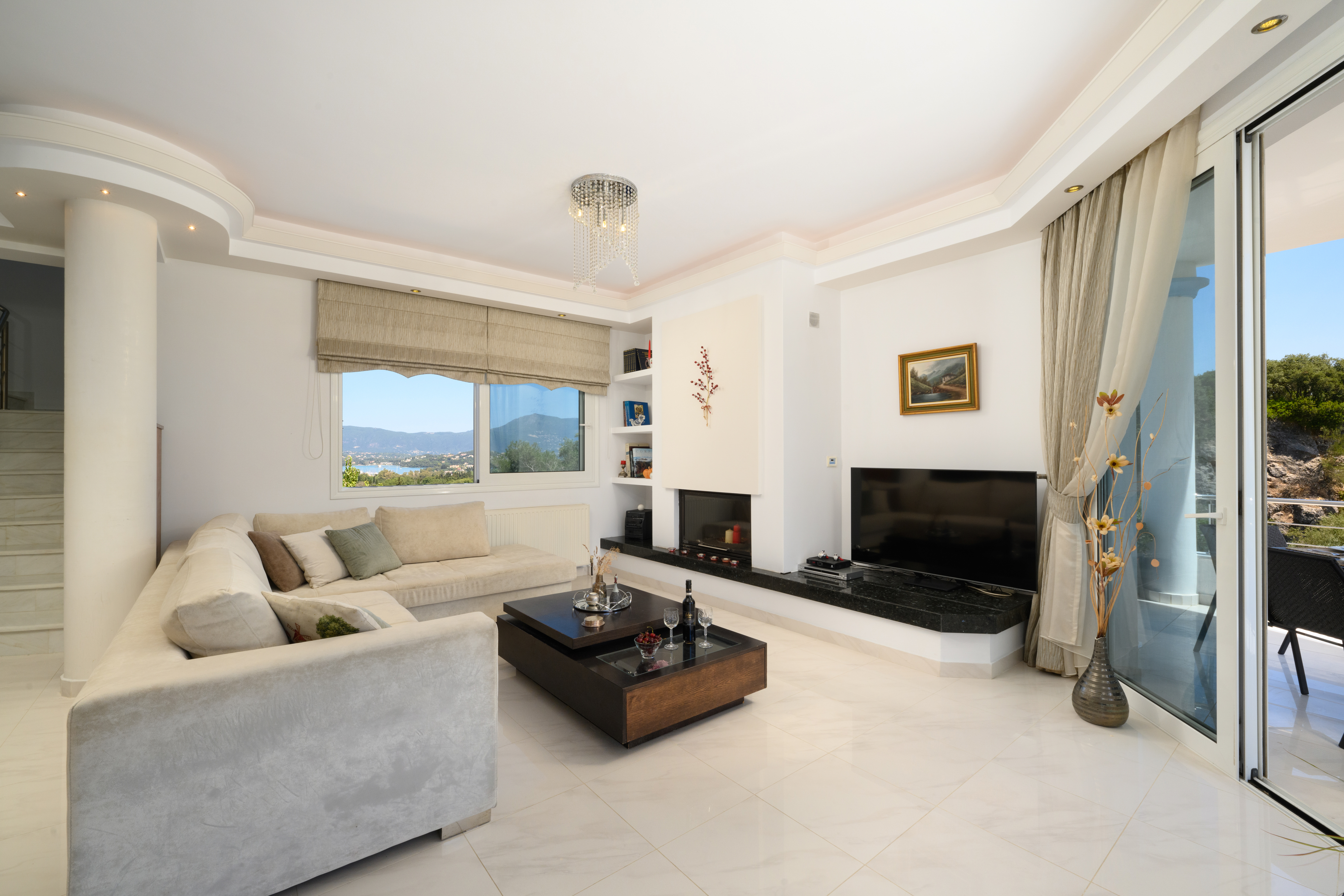 Elegant living room with fireplace in the luxury villa in Corfu