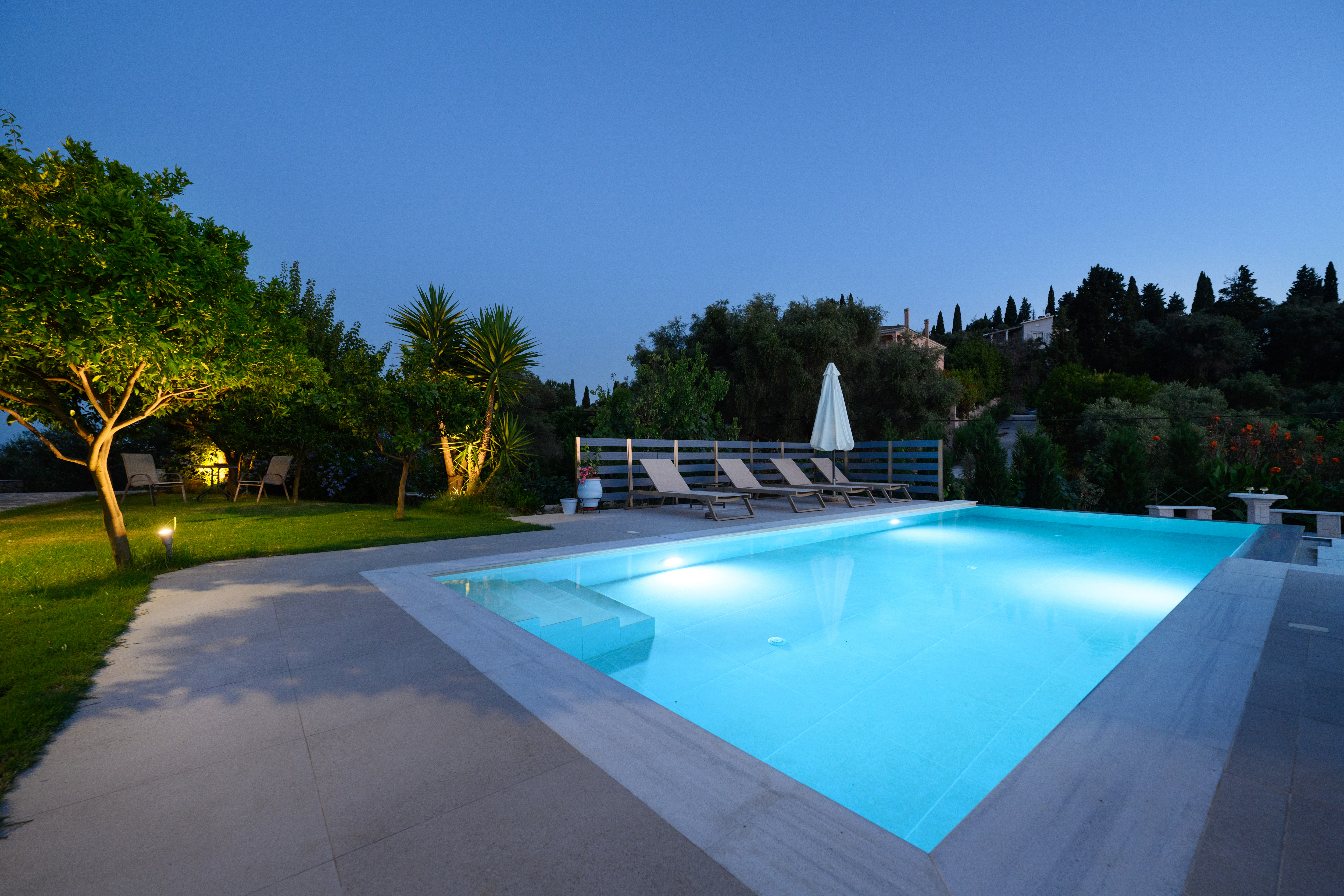 Night view of Olga’s Luxury Villa and illuminated infinity pool