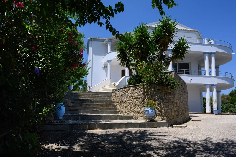 Entrance of Olga’s Luxury Villa holiday home in Corfu surrounded by greenery