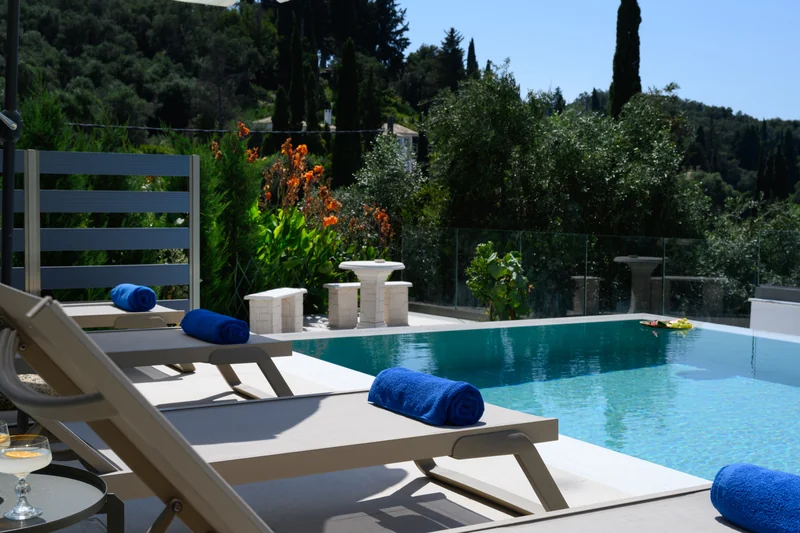 Sunbed beside the infinity pool with Ionian Sea view at Olga’s Luxury Villa
